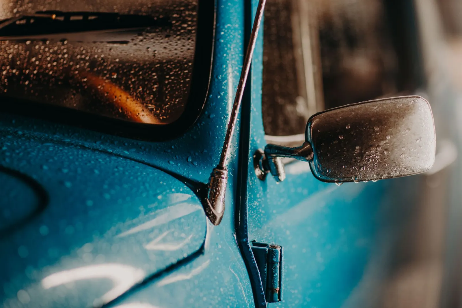 Water beading on a freshly ceramic-coated dark vehicle hood