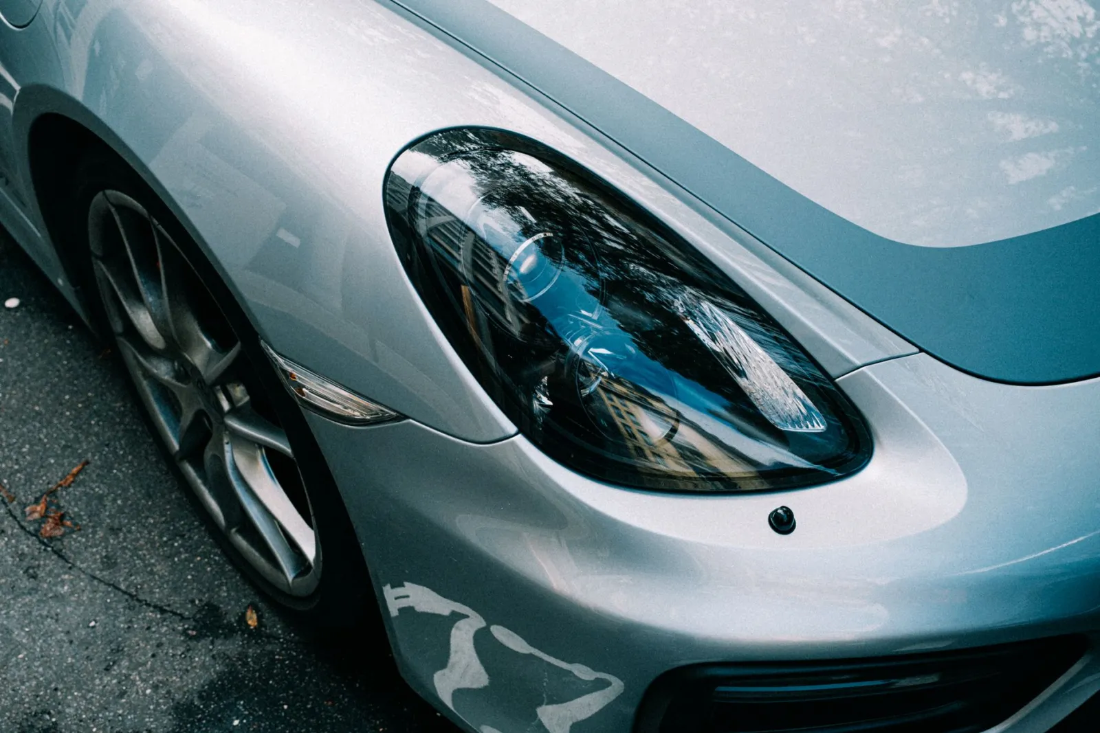 close-up of water beading on a silver car hood after ceramic coating