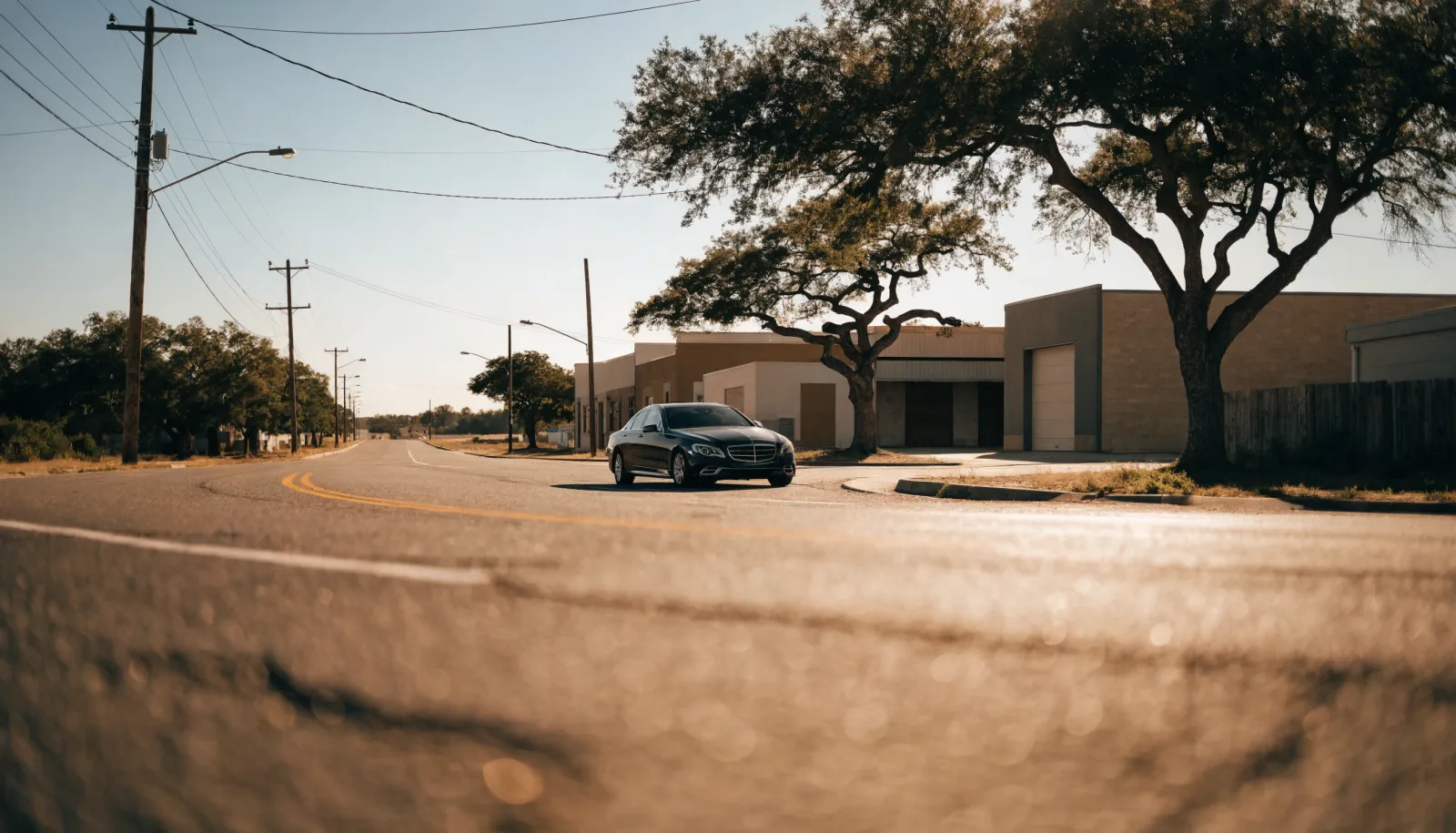 Quiet light-industrial road on the edge of a Texas town in clear afternoon light