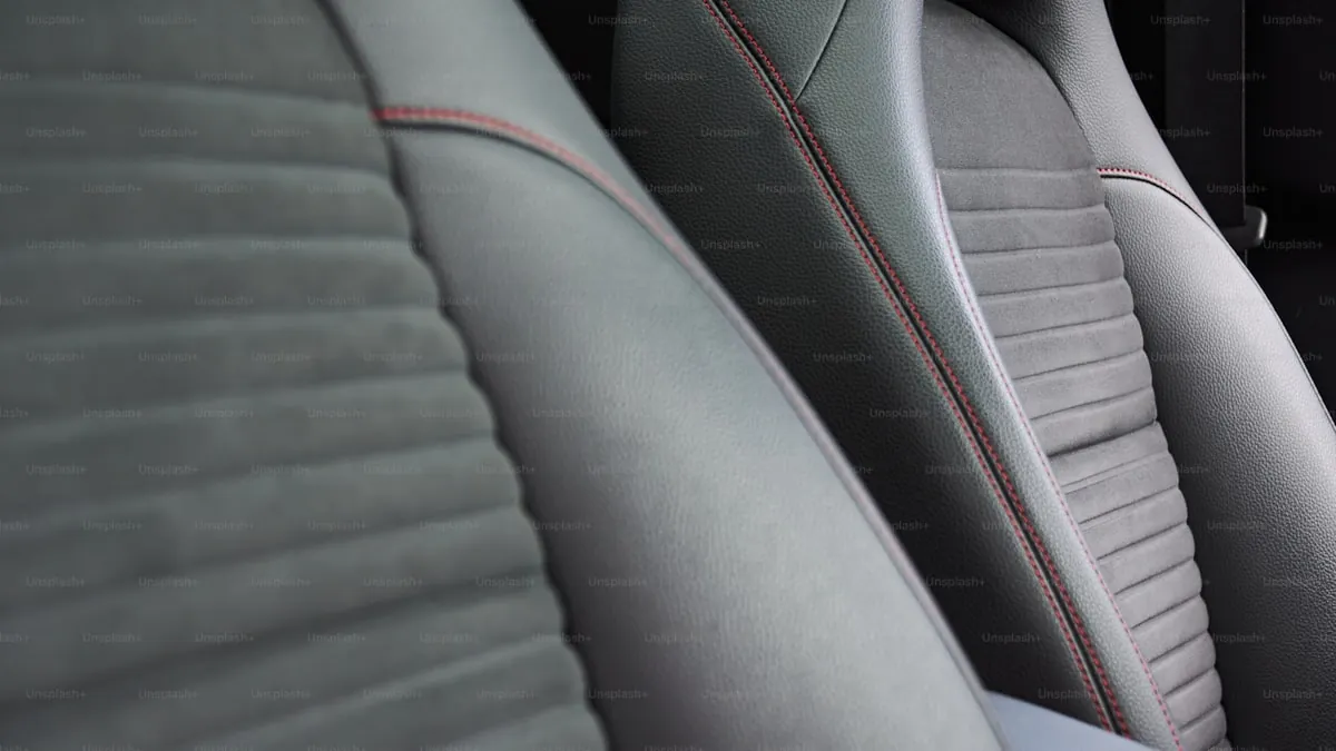 Professional interior detailing showing clean leather seats and dashboard