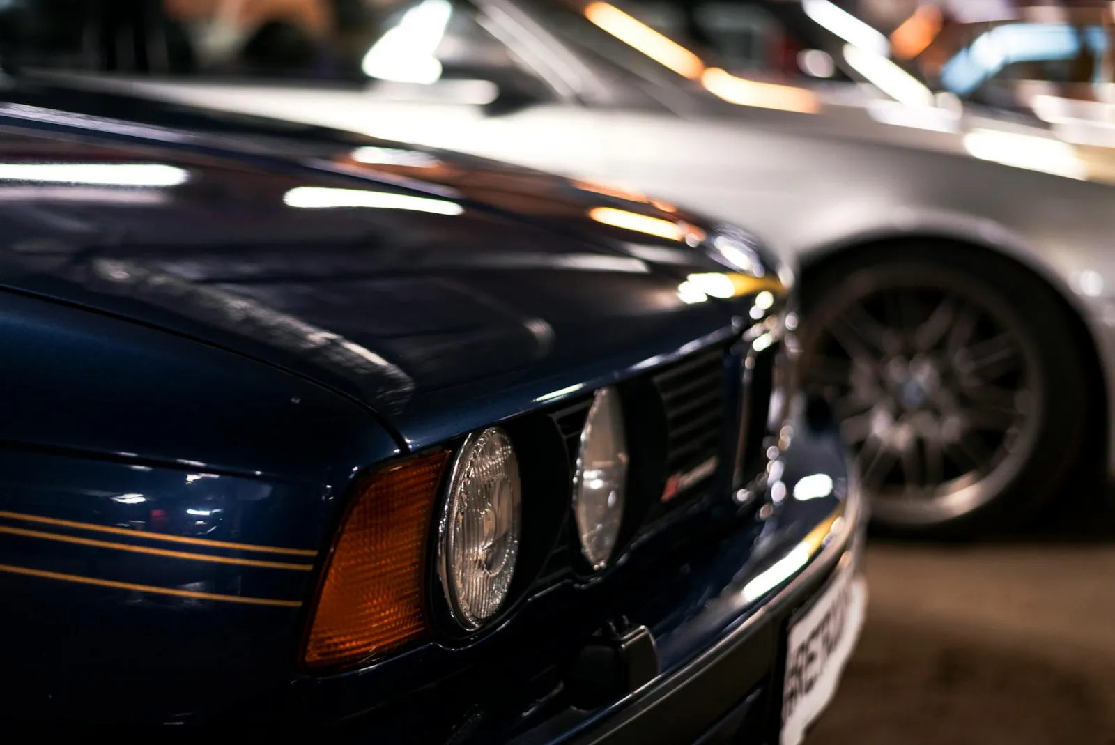 Dark blue sedan exterior showing reflective paint surface under bright light