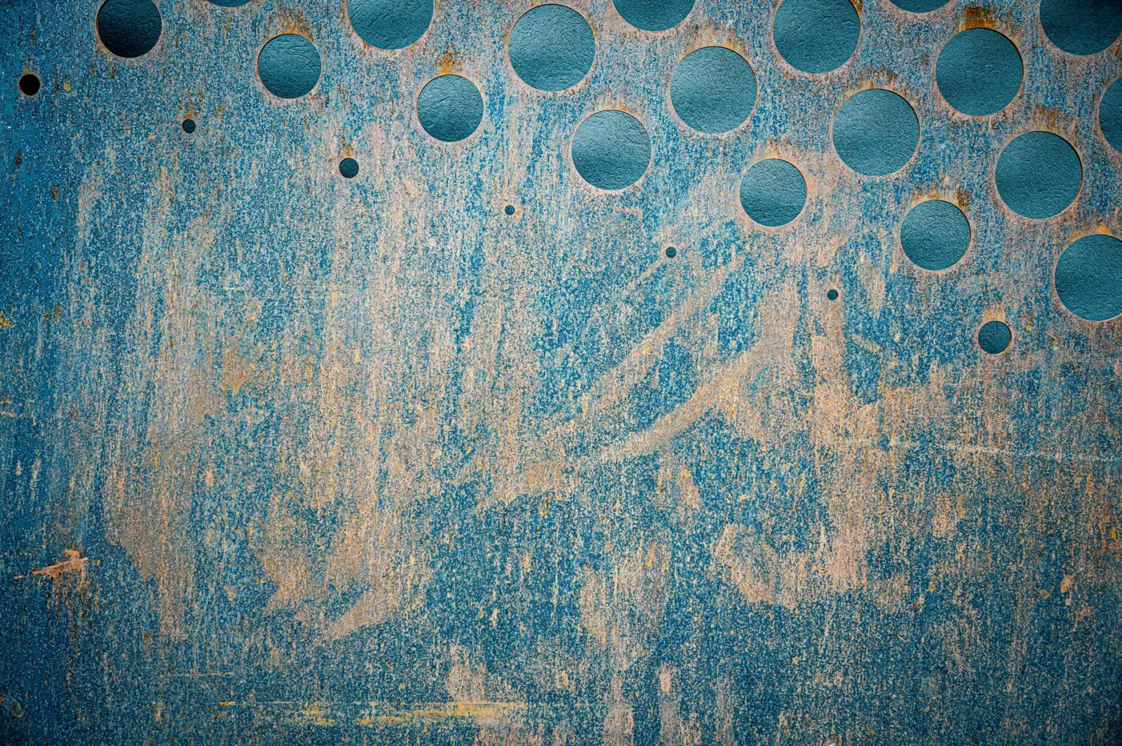 Close-up of heavily oxidized and faded automotive clear coat on a dark vehicle