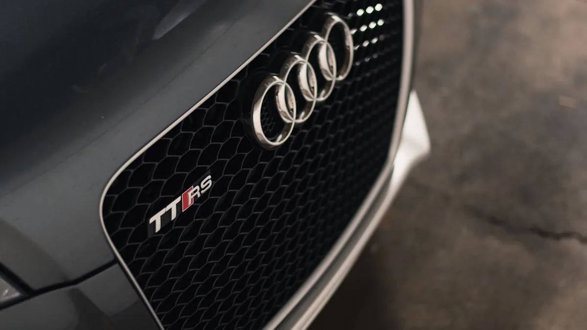 Audi RS model with paint protection film being applied to the front bumper