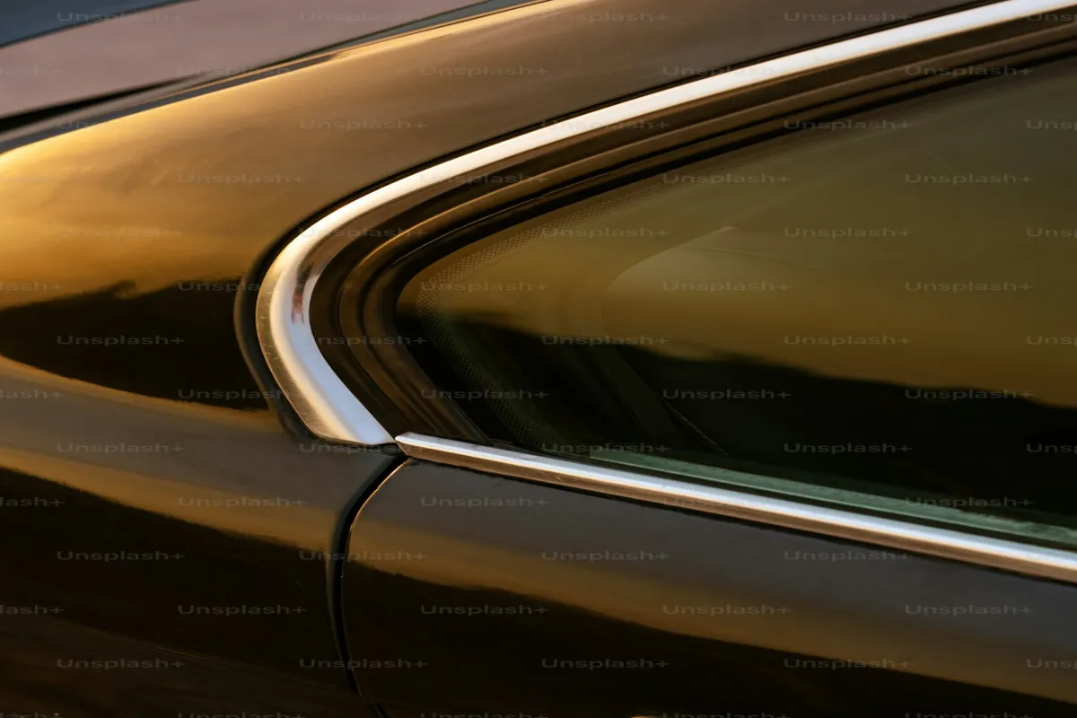 close-up of a car door edge showing paint protection film applied along the opening